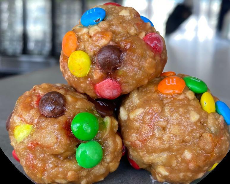Peanut Butter M&M Lean Cheats · Natural peanut butter, honey, M&M minis, rice crispy, vanilla whey protein.

Enjoy our hand-rolled, flavorful, bite-sized protein balls, made with fresh ingredients and high-quality protein. (6 balls per container, 3 balls per serving.)