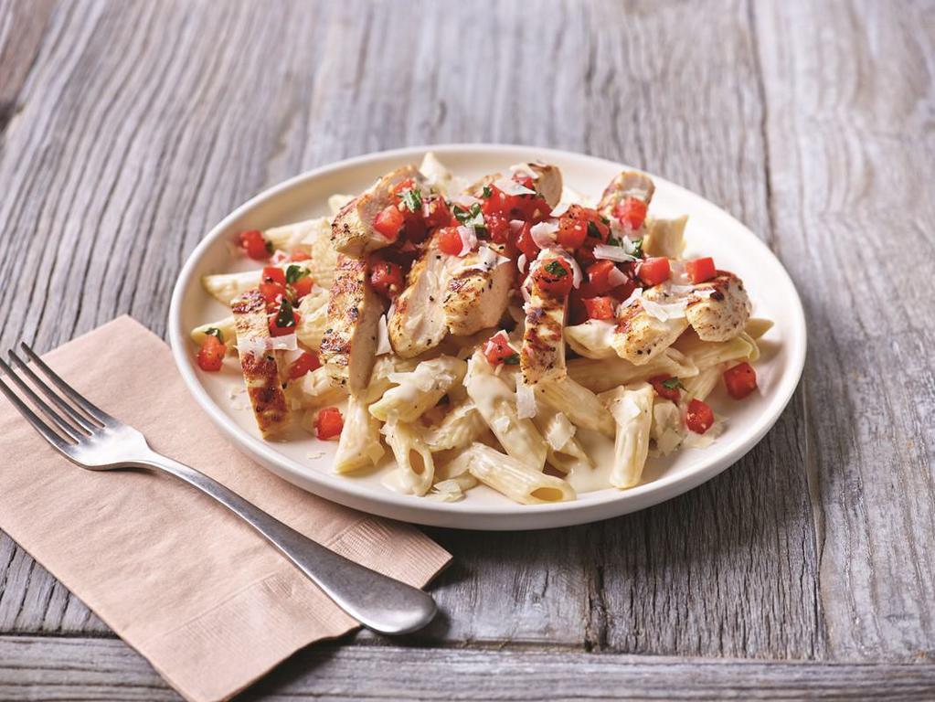Three-Cheese Chicken Penne · Asiago, Parmesan and white Cheddar cheeses are mixed with penne pasta in a rich Parmesan cream sauce then topped with grilled chicken breast and bruschetta tomatoes.