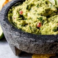 Fresh Guacamole · Served with chips.