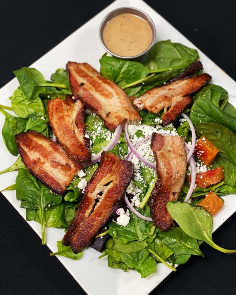 Spinach Salad · Fresh baby spinach greens, red onions, crumbled goat cheese, roasted red & gold beets, with braised pork belly.  Goes great with cider vinaigrette. 
PLEASE NOTE:  SPECIAL INSTRUCTIONS OR REQUESTS MAY NOT BE FOLLOWED.