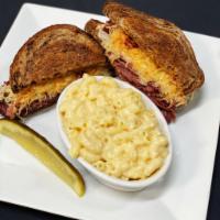 Corned Beef Reuben · House-made corned beef, sauerkraut, Russian dressing, & Swiss on toasted rye.  Served with o...