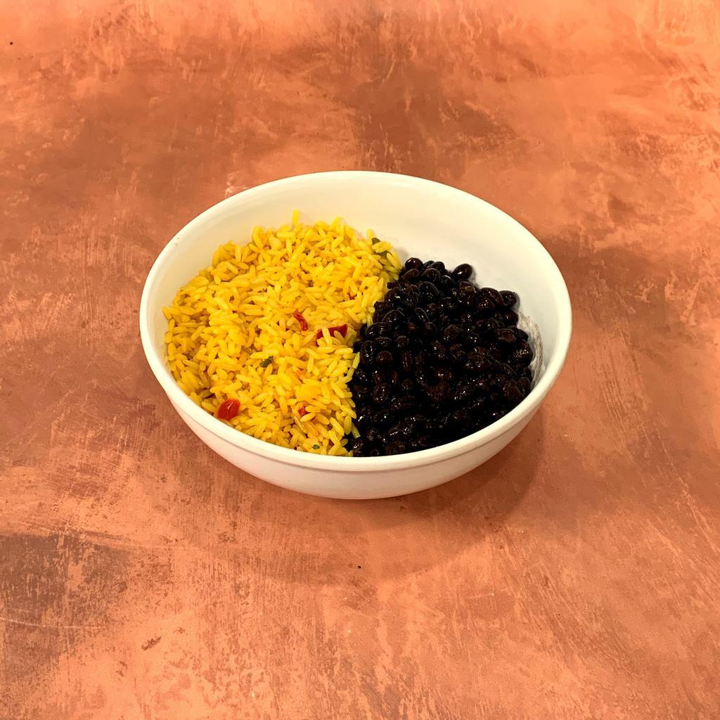 Rice & Black Beans · Rice cooked with sauteed onions, chopped red peppers, and chicken consomme. Served with our housemade black beans in a 6 oz. Container.