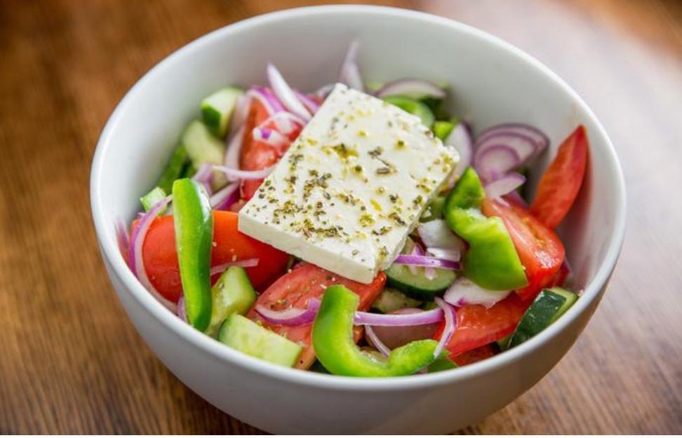 Horiatiki Greek Salad · Tomato, cucumber, green peppers, kalamata olives, red onion, olive oil, and imported Greek feta, served with pita bread.