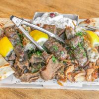 Mix Grill plater · Lamb, chicken, and pork gyro, chicken and pork souvlaki (skewers), loukaniko (Greek sausage)...