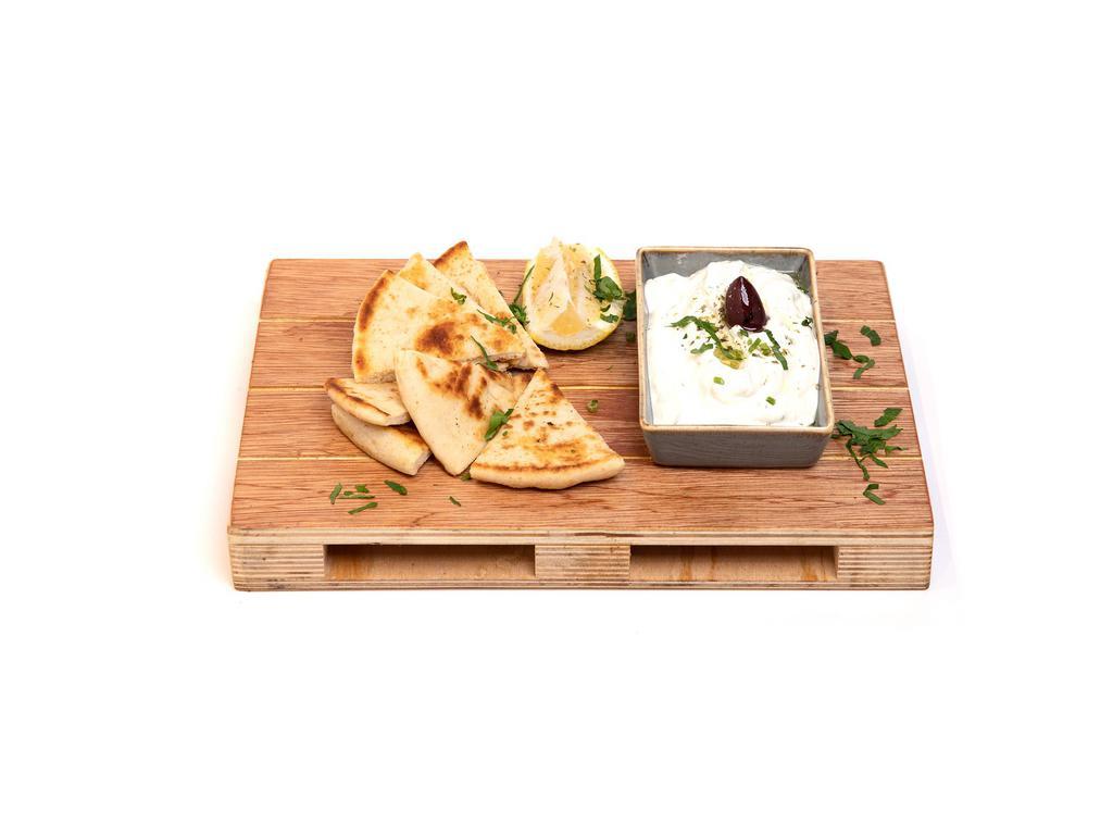 Tzatziki · Classic Greek yogurt spread with cucumber, garlic and fresh dill. Served with pita bread.
