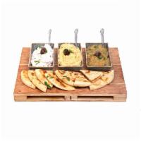 Taste of Spreads · Your choice of three dips, served with three pita breads.