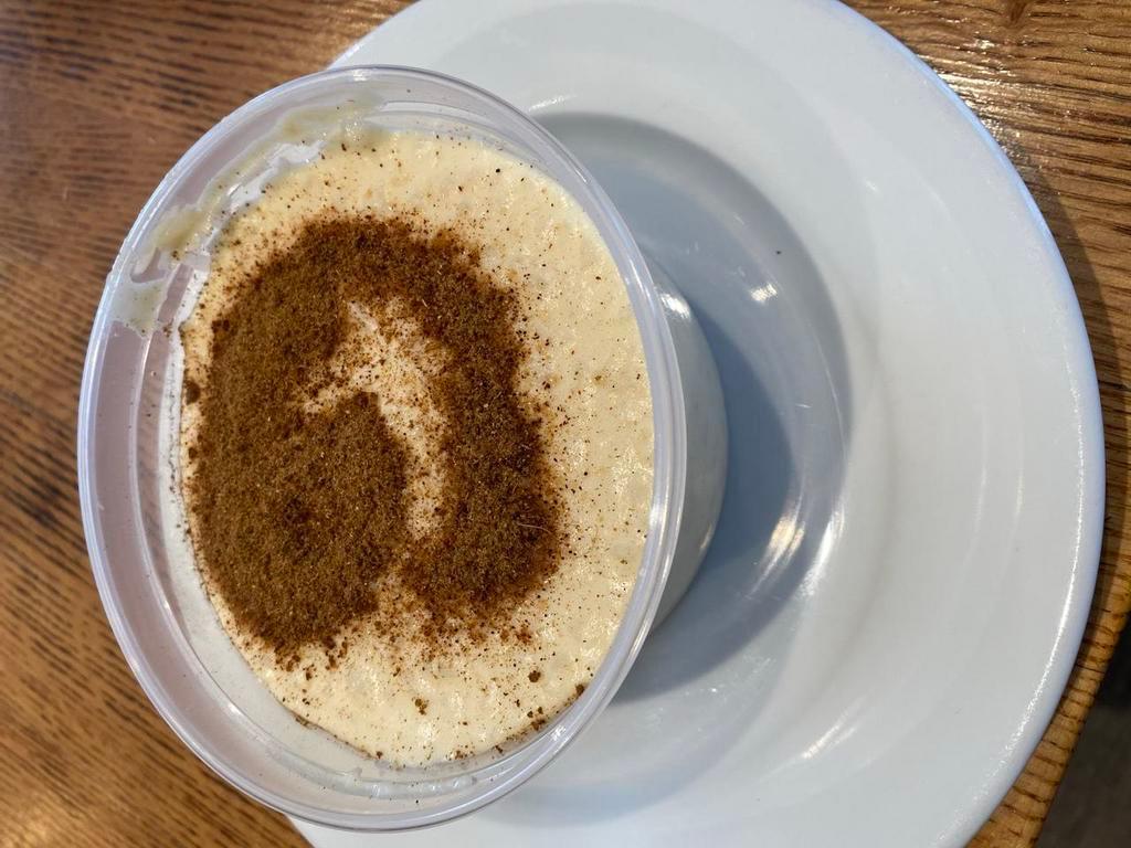 Rice Pudding · Creamy rice pudding topped with cinnamon.