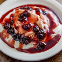 Greek Yogurt · Greek yogurt served topped with honey or sweet cherries.