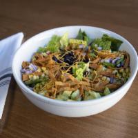 Southwestern Taco Salad · Romaine, grilled corn, black beans, avocado, tomato, red onion, blend of cheeses, crispy tor...