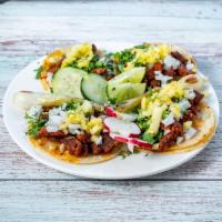 Al Pastor Taco · Roasted pork tacos topped off with a special touch of pineapple.