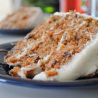 Carrot Cake · Triple layer with real cream cheese, walnuts, and golden raisins.