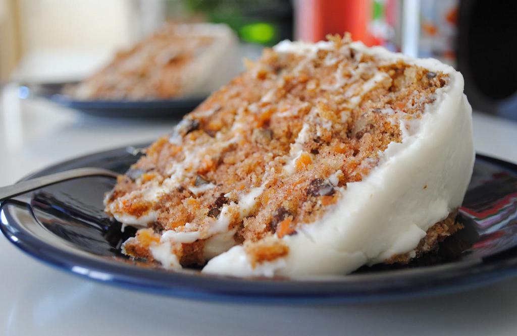 Carrot Cake · Triple layer with real cream cheese, walnuts, and golden raisins.