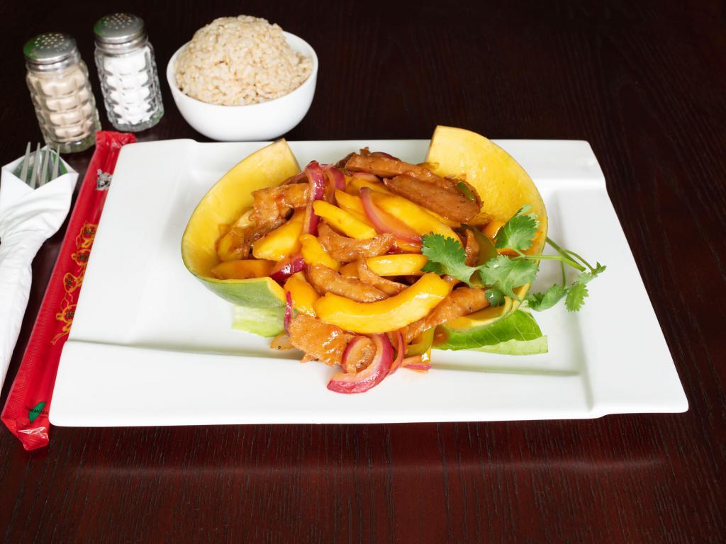 M4. Mango Chicken · Fresh strips of mango, vegetarian chicken sauteed onions and red bell peppers sauteed in a citrus Thai marinade. Served in a mango shell. Spicy.