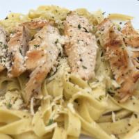 Chicken Alfredo · Fresh cooked chicken breast on a bed of our fettuccine noodles tossed in our Signature Alfre...