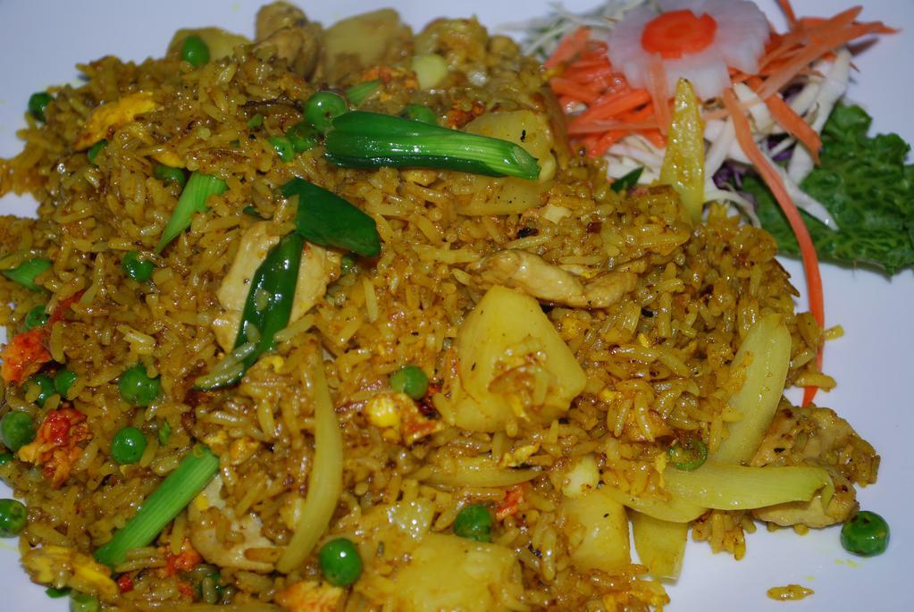 Pineapple Fried Rice · Jasmine rice stir fried with your choice of protein, pineapple chunks, onions, green peas, eggs and a dash of turmeric powder.