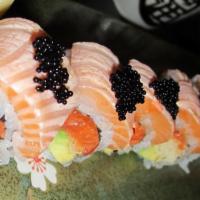 Alaskan Beauty Roll · Spicy salmon, avocado and crunchy flakes inside with seared salmon and caviar on top.