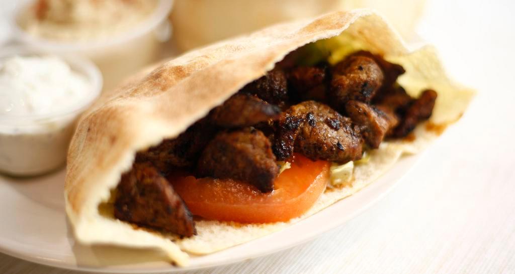 Grilled Beef Steak Pita Sandwich · Served with lettuce, tomato and hummus. Includes a side.