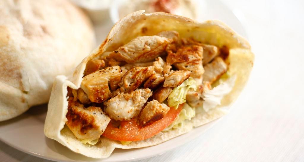 Grilled Chicken Breast Pita Sandwich · Served with lettuce, tomato and hummus. Includes a side.