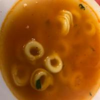 Tortellini in Brodo · Light chicken consomme with homemade cheese tortellini.