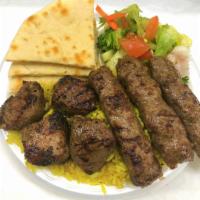 Mix Grill Plate · 4 pieces lamb kabob and 3 pieces lamb sausage. Comes with rice, bread, sauce and mix salad.