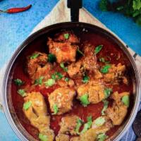 Chicken Curry · Traditional curry prepared with onion tomatoes and other herbs.