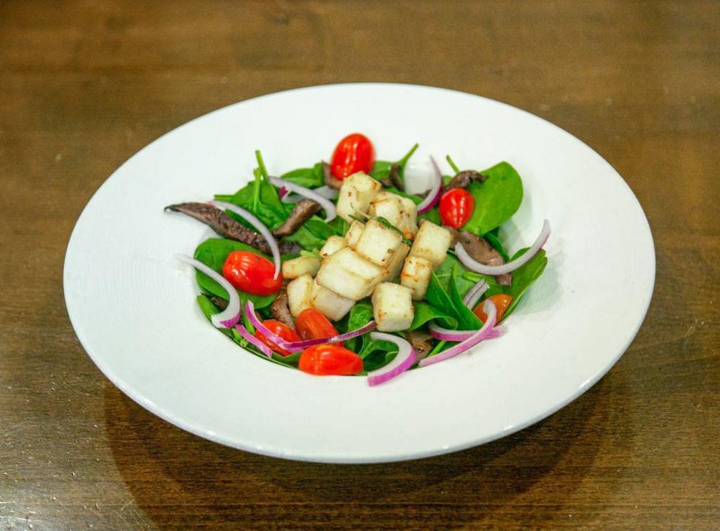 Grilled Halloumi Salad · Baby spinach base, portobello mushrooms, sweet potatoes, cherry tomatoes, red onions sauteed in teriyaki sauce with grilled halloumi cheese,  olive oil and rosemary dressing.
