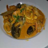 Corvina a lo Macho · Fried blue snapper served with a spicy creamy sauce, shrimp, calamari, octopus and clams. Se...