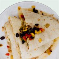 BLACK BEAN FIESTA QUESADILLA · Black beans, quinoa, roasted peppers and onions and melted Jack cheese in a spinach tortilla...