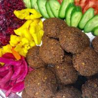 Falafel (Vegan and GF) · Crispy chickpea patties served with tahini sauce and toppings.