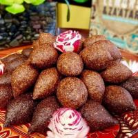 Kibbie Balls · A shell of finely ground lamb, bulgur and spices stuffed with lamb, pine nuts, almonds and o...