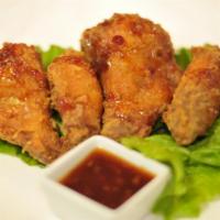 Siam Wings · Tender chicken wings marinated with a blend of Thai spices and lightly fried. Served with ou...