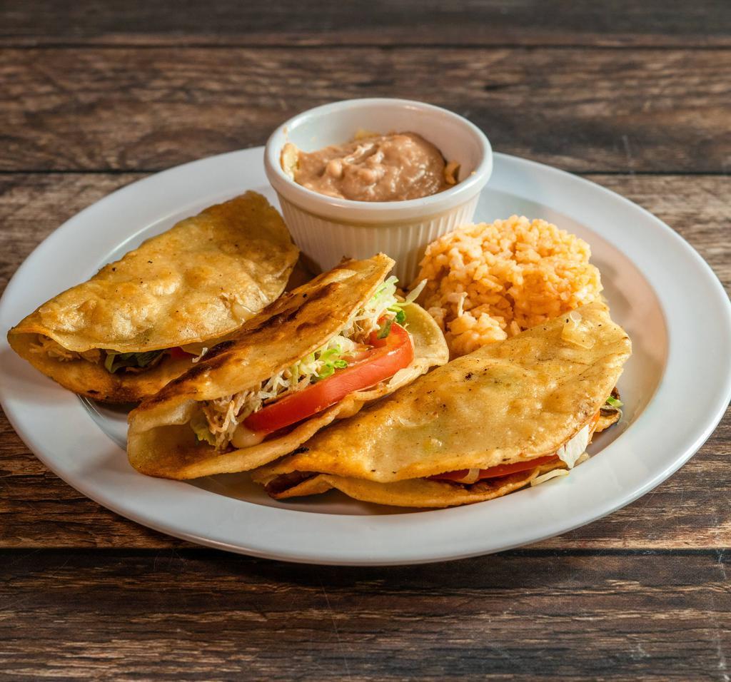 Fried Tacos · 3 crispy tacos filled with your choice of chicken, ground beef or shredded beef with salad and cheese on top served with rice and beans.