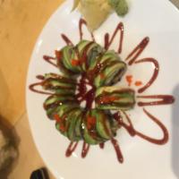 142. Dragon Roll · Sliced avocado topped on an eel cucumber roll with tobiko.