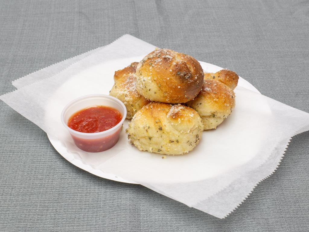 4 Garlic Knots · Extra fluffy knots, tossed with fresh garlic, chopped parsley, a blend of grated cheeses and a touch of extra virgin olive oil. Tomatoe sauce on the side 