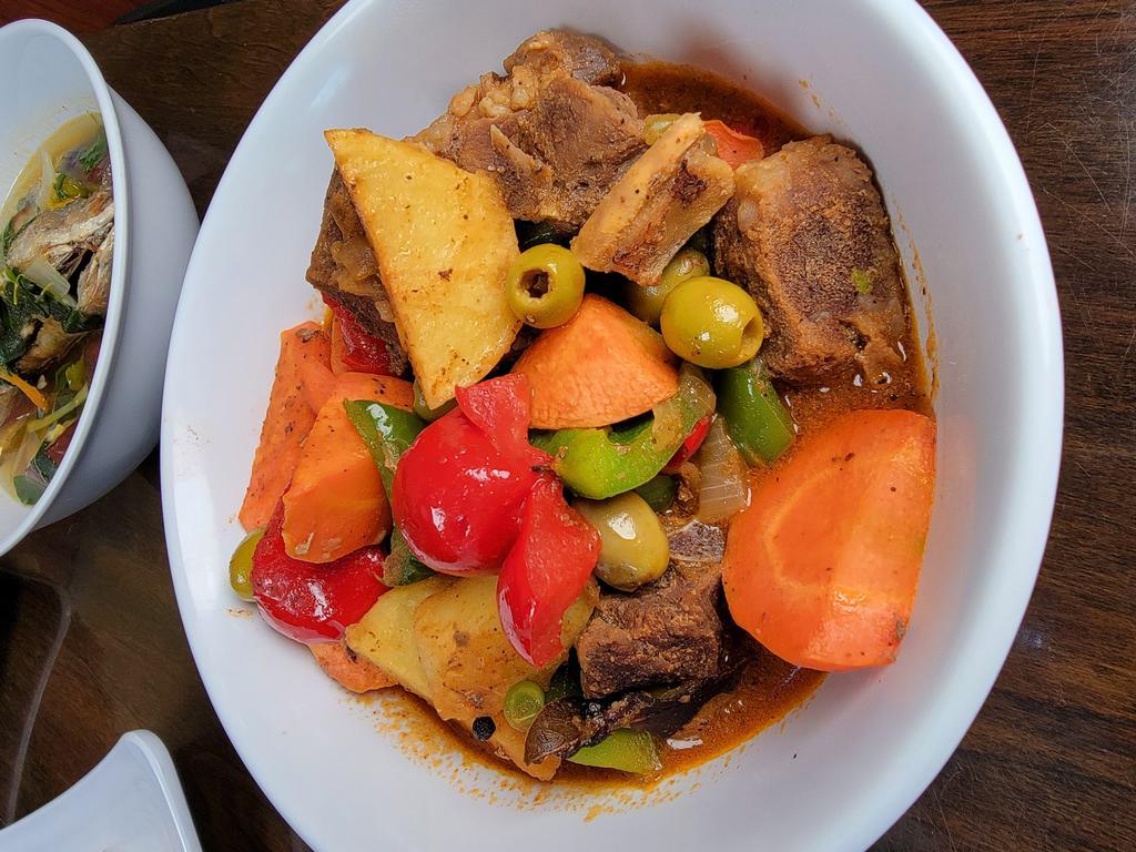 Kalderetang Kambing · goat meat  stewed with vegetables and liver paste. tomatoes, potatoes, olives, bell peppers, and hot peppers
