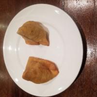 Chicken Samosa · A triangle of shaped pastry stuffed with lightly spiced chicken mince, diced potatoes, green...