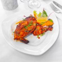 Tandoori Chicken · Tender pieces of chicken marinated with spices, herbs, ginger, and garlic paste and grilled ...