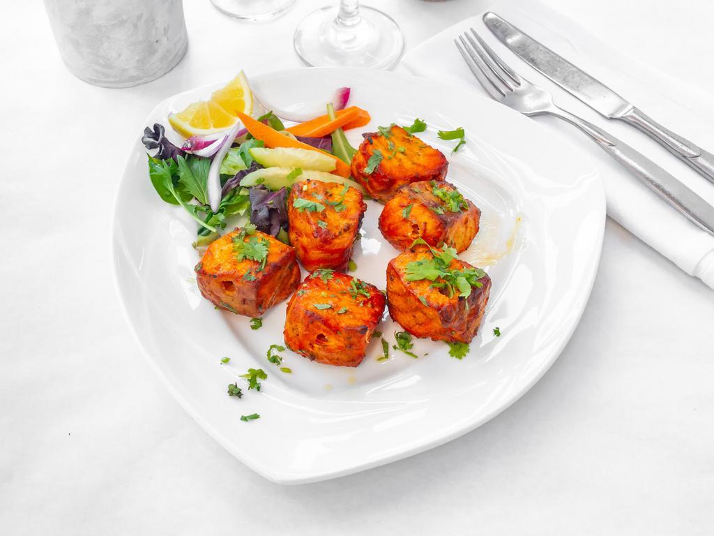 Fish Tikka · Salmon. Cubes of seasoned fish marinated in sour cream, aromatic herbs, and spices, skewered and cooked in tandoor.