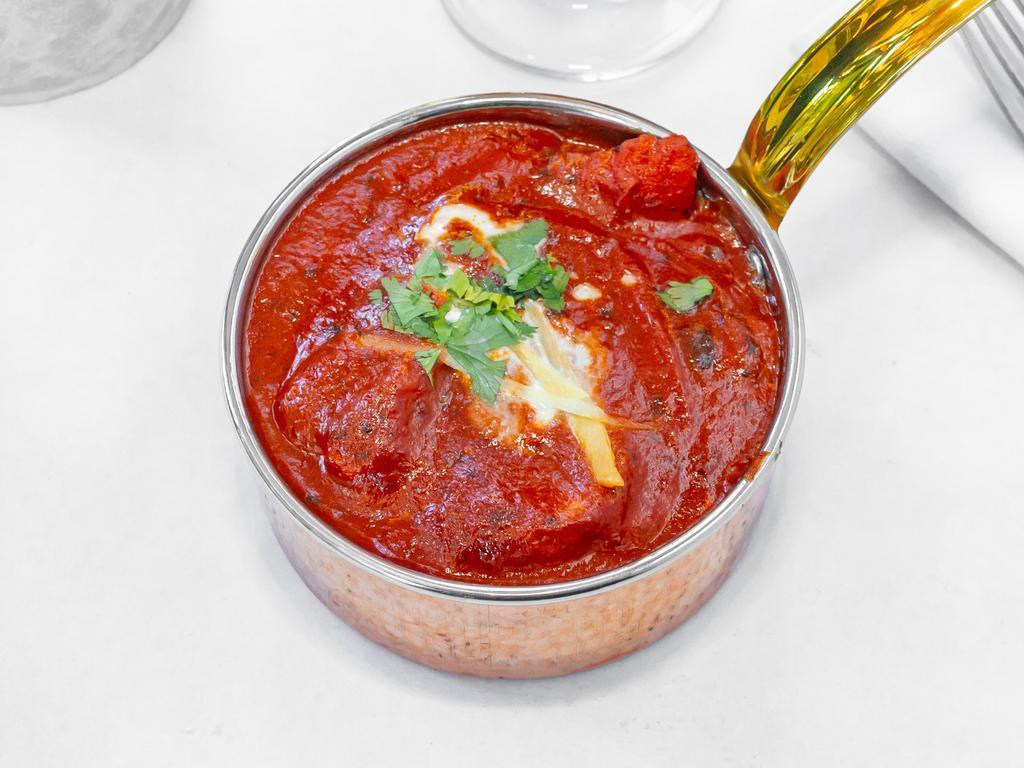 Chicken Tikka Masala · Boneless cubes of chicken marinated and grilled in a clay oven and simmered in a tangy sauce of light cream and tomatoes.
