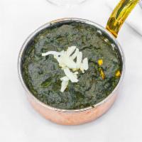 Palak Paneer · Cubes of freshly made cottage cheese cooked with spinach, onion, garlic, ginger, and seasoni...