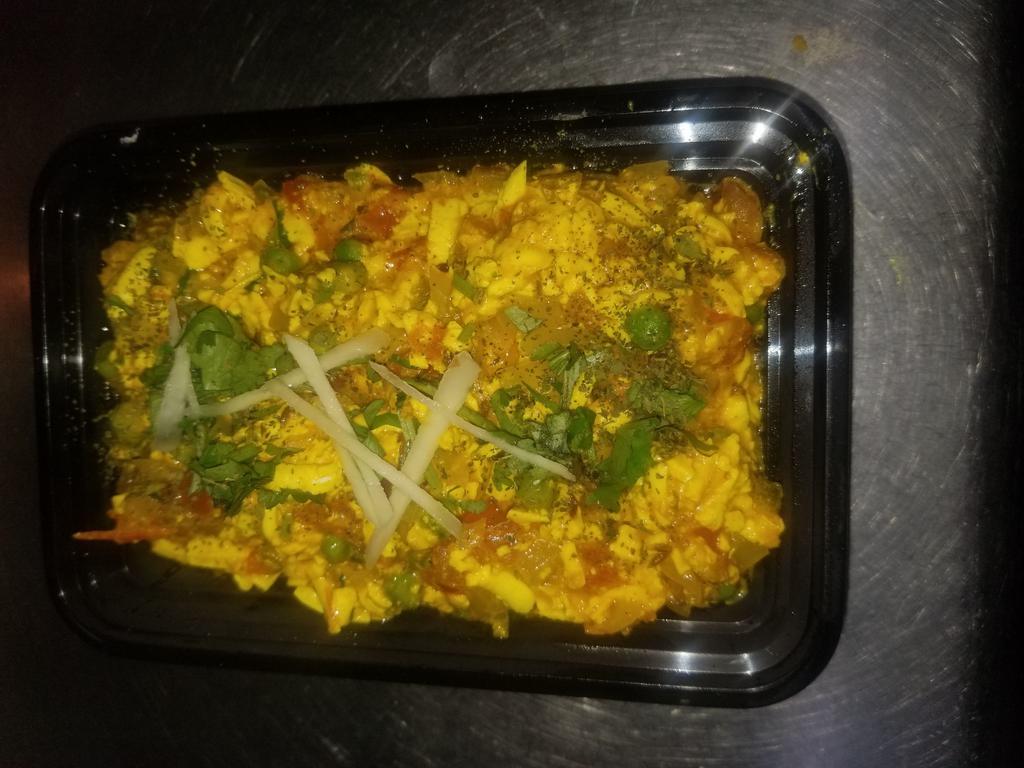 Paneer Bhurji · Homemade cottage cheese minced and sauteed with onion, green chilis, garlic, peppers, tomato, and garnished with fresh coriander.