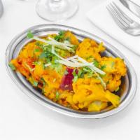 Aloo Gobhi · Florets of cauliflower and potatoes cooked in a wok with cumin seeds, tomato, spices, and he...