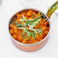 Chana Masala · Kabuli chick peas cooked with onion, ginger, garlic, tomatoes, cumin, coriander, red chilis,...