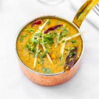 Dal Makhani · A delicious preparation of black lentils simmered overnight with onions, turmeric, ginger, g...