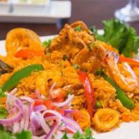 Arroz con Mariscos · Peruvian paella: spiced rice with fish, shrimp, calamari, clams and mussels. Served with sal...