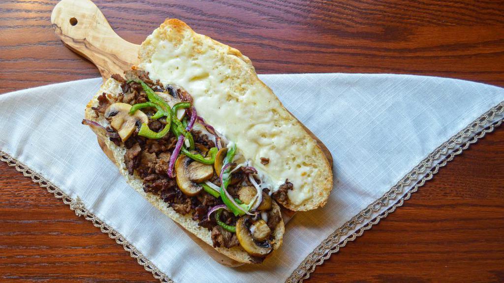 Philly Cheese Steak Sub Roll · Thinly sliced steak, onions, green peppers and mushrooms. Baked with mozzarella cheese.