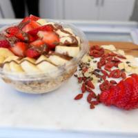 Strawberry Island Acai Bowl · Acai topped with strawberry, banana, chocolate macadamia drizzle, granola.