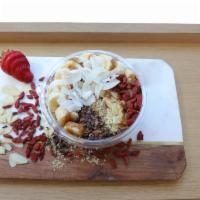 Superfood Edge Acai Bowl · Acai topped with banana, almond slices, goji berries, coconut flakes, cacao nibs, hemp seeds...