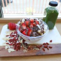 Coco Classic Coconut Bowl · Coconut topped with banana, strawberry, cacao nibs, coconut flakes, chocolate macadamia driz...