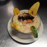 5. Leche de Tigre · Tiger's milk, concentrated Peruvian ceviche, marinated with generous chunks of fish and topp...